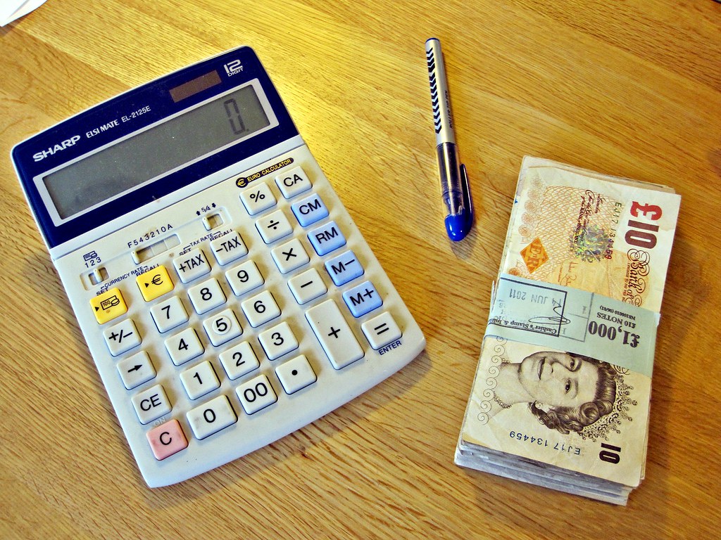 A calculator and pen on a document