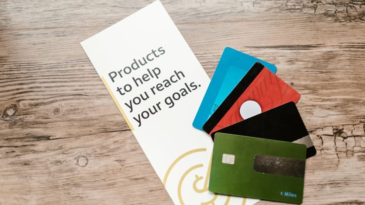 A fan of payment cards on a wooden table