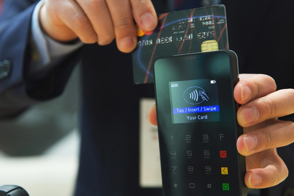 A credit card resting on a bank statement