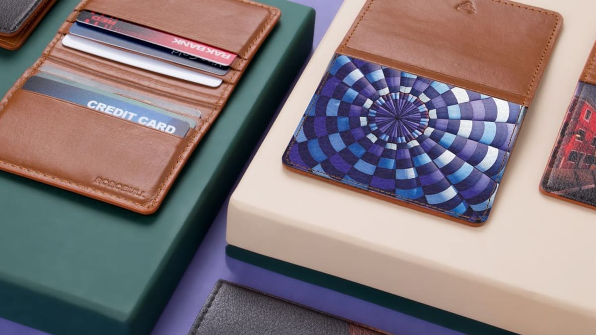 A leather wallet holding several cards