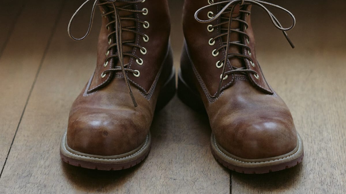 A pair of work boots by a door