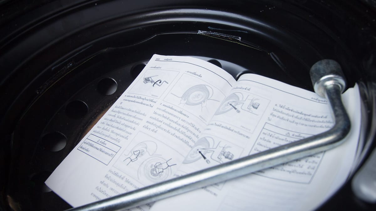 A person reading paperwork at a kitchen table