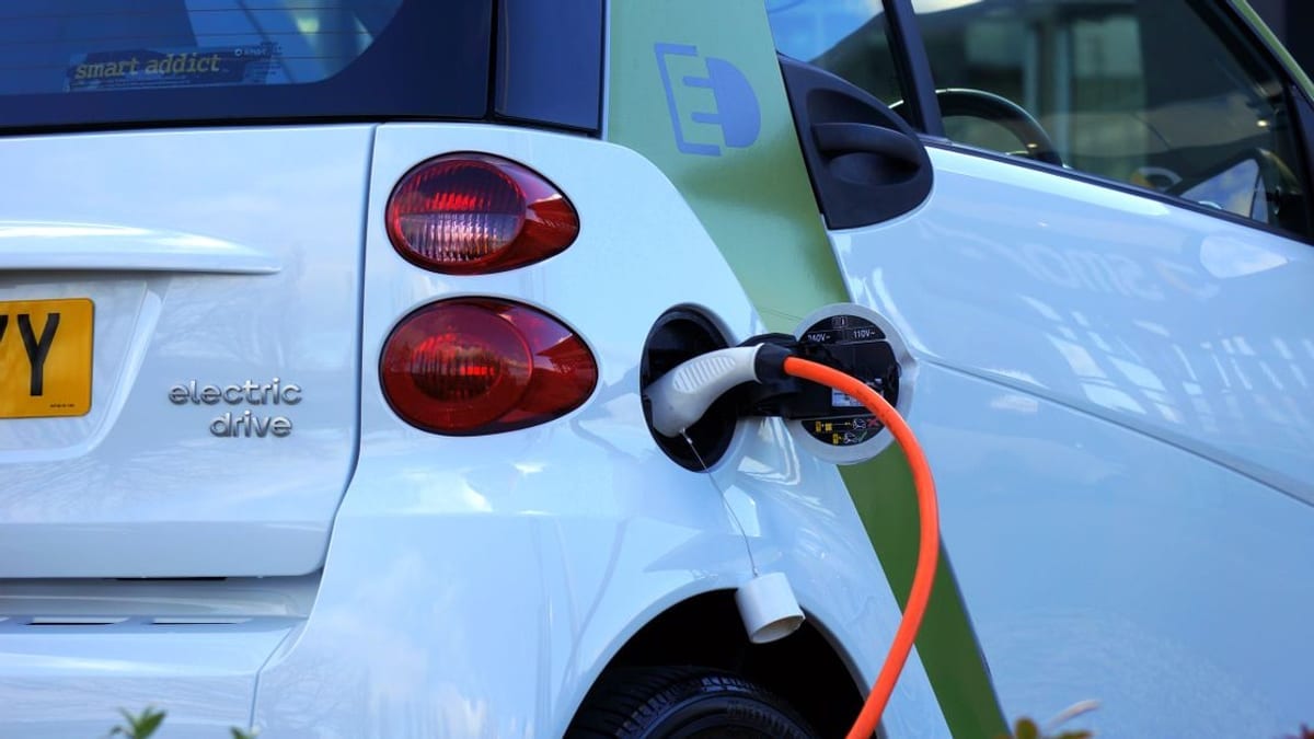 A charging cable plugged into an electric car