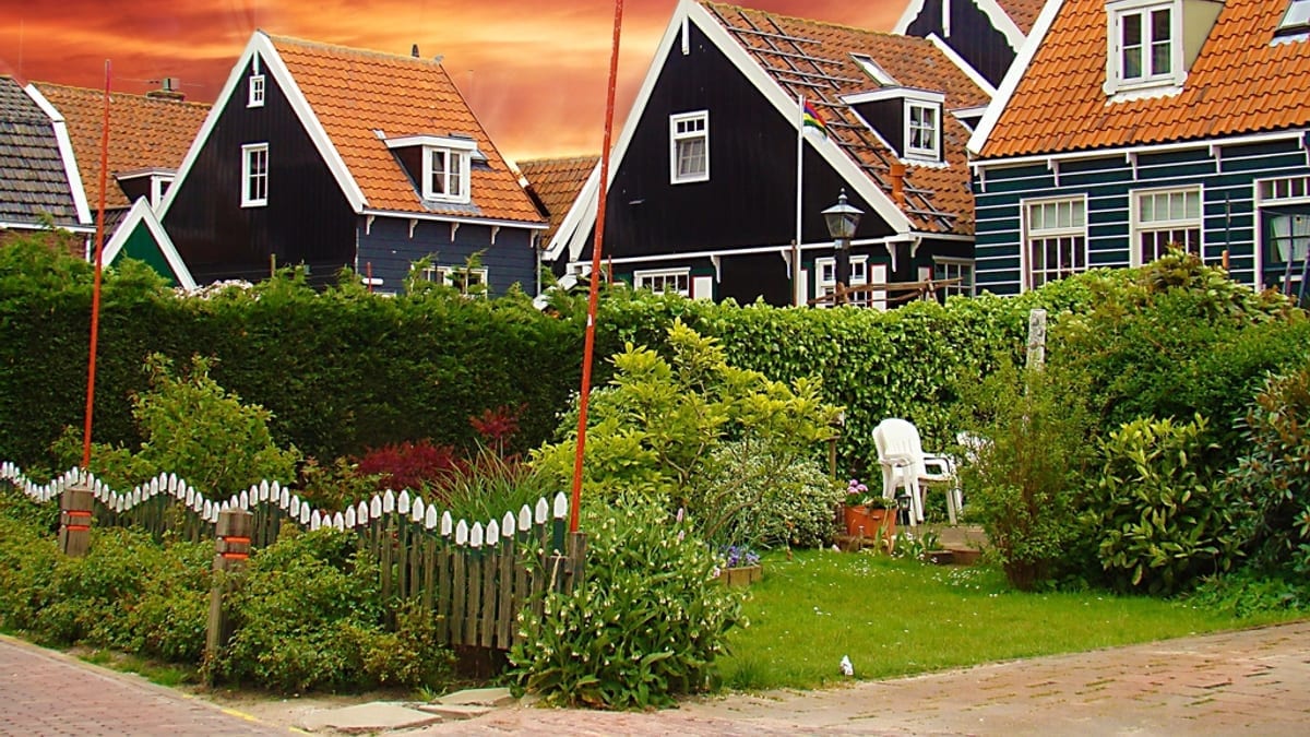 Houses with steep roofs under an evening sky