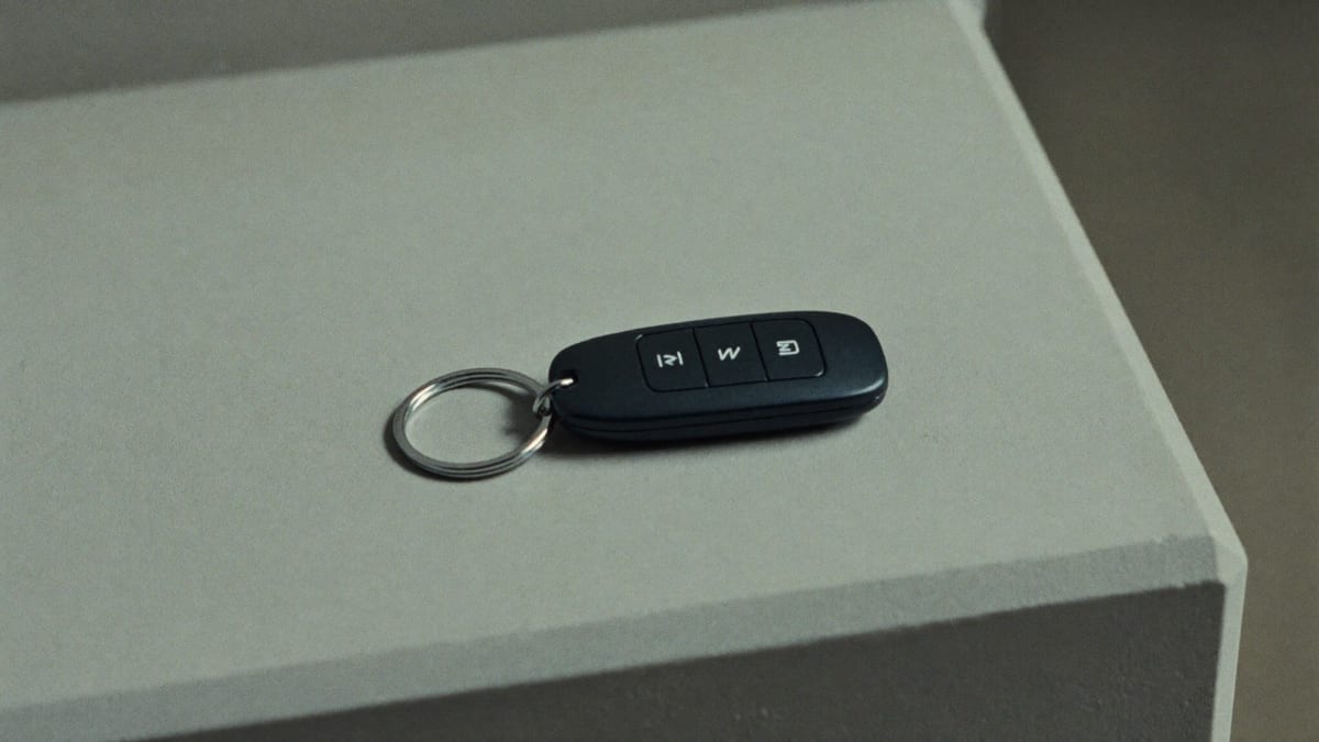 A car key fob on a plain surface
