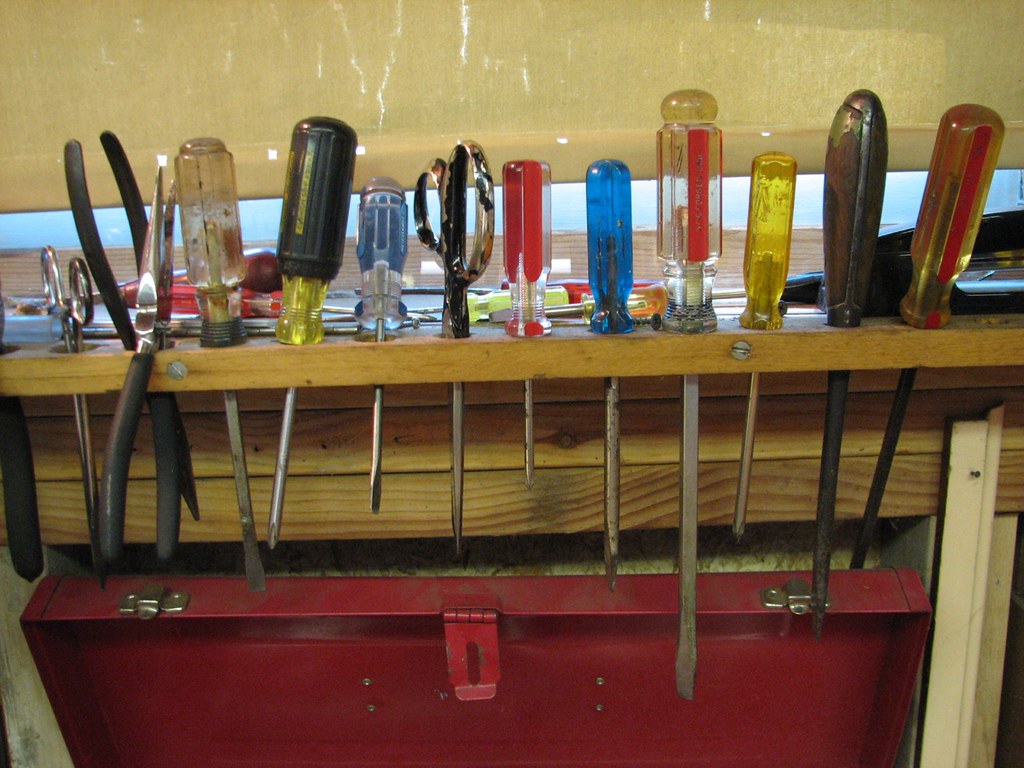 A toolbox and notepad on a workbench