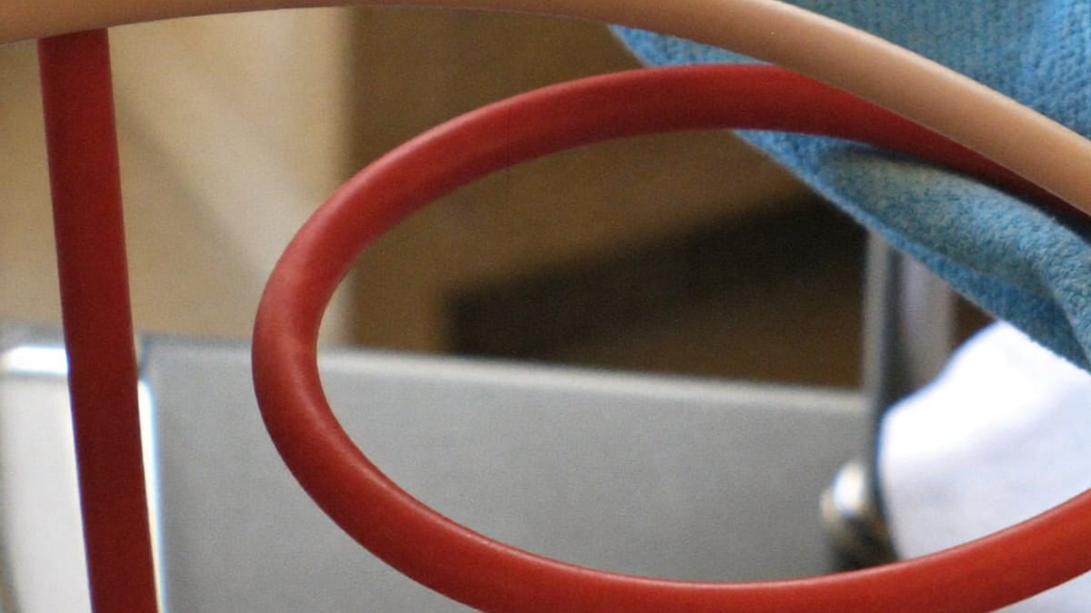 Two coloured tubes coiled on a clinic trolley