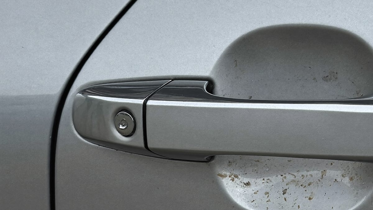Close-up of a car door handle in daylight