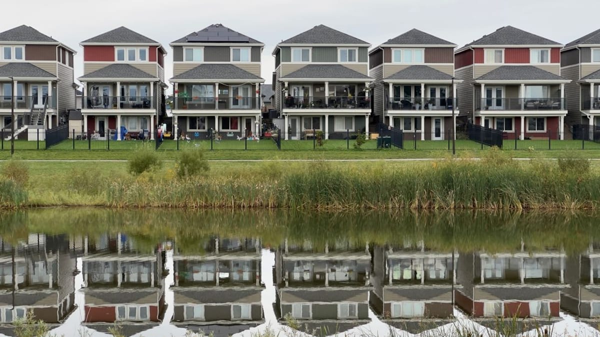 Apartment buildings reflected in still water
