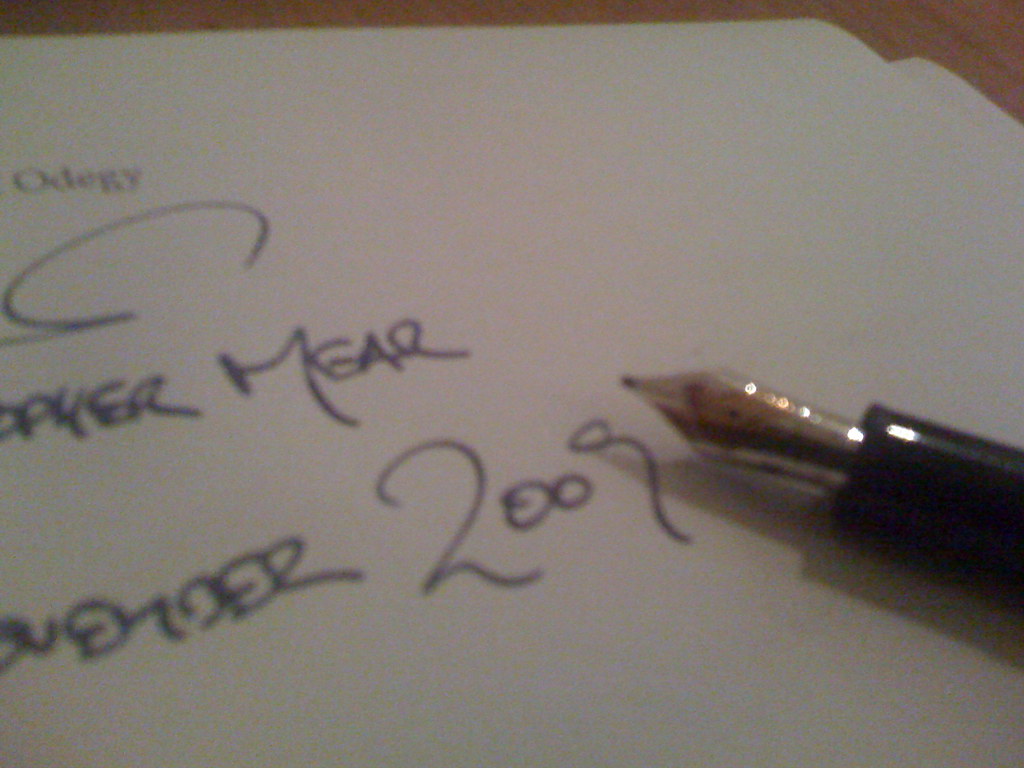 A document being signed with a pen