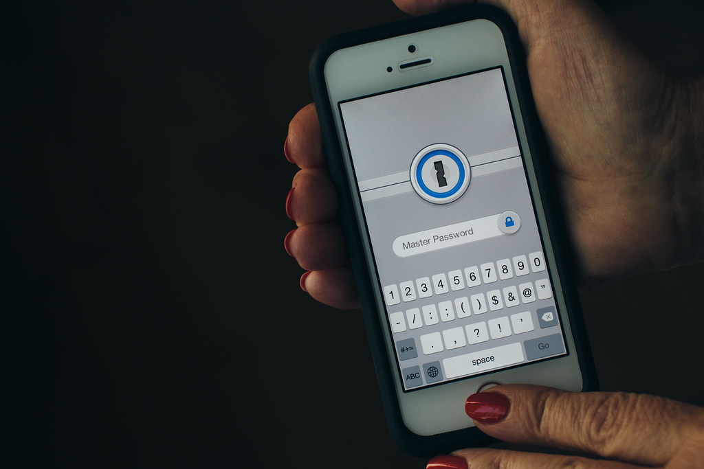 A phone showing a temporary verification code beside a login screen