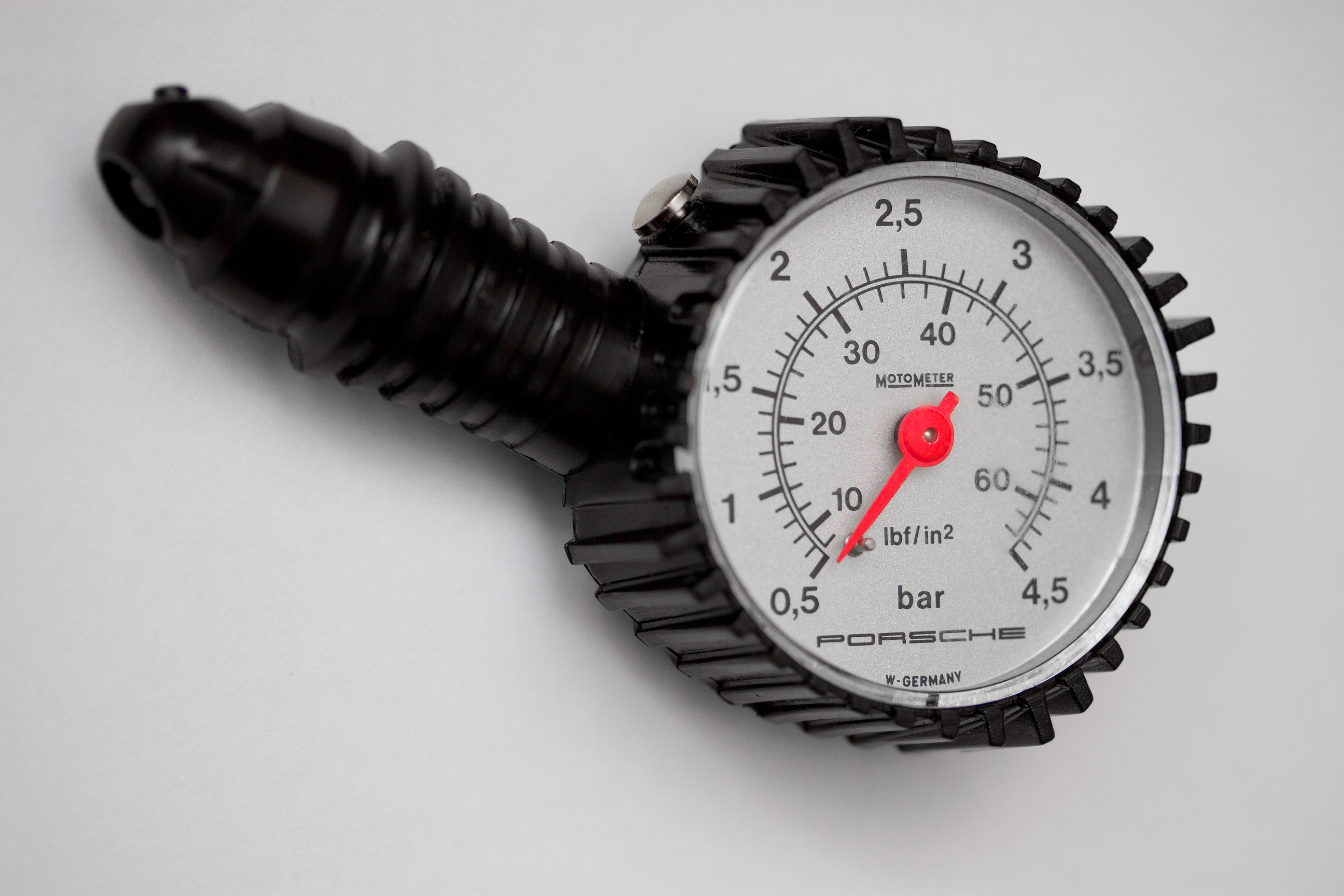 A pressure gauge attached to a car tyre valve