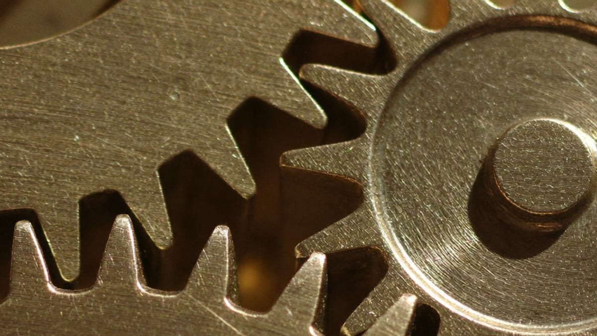 Close-up of two meshing brass gears