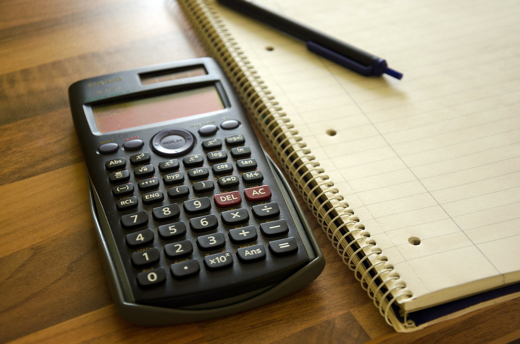A calculator and notepad