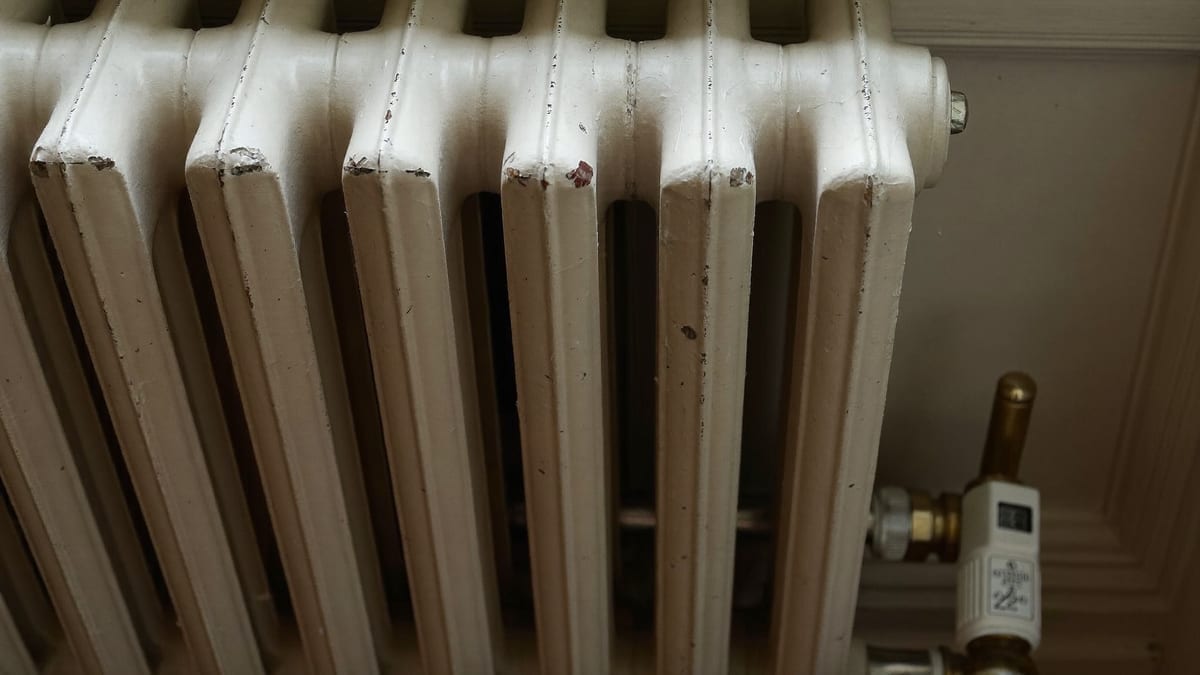 A domestic radiator against a plain wall
